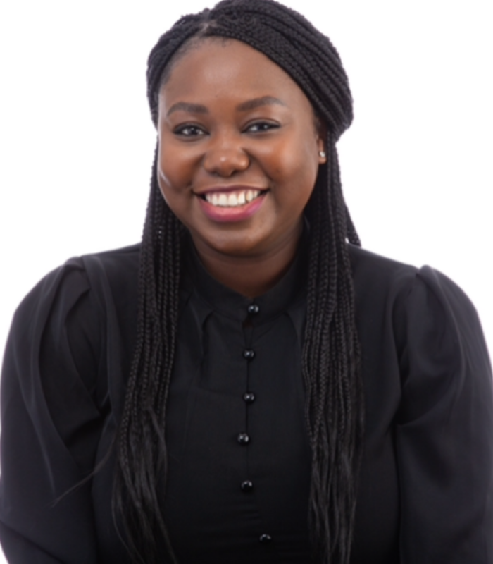 Meet Our Team - Professional and Welcoming Group at a Conference Table Faces the Camera, Team Leader Sitting on the Table with Arms Folded